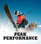 Person skiing with 'Peak Performance' branding on a snowy background