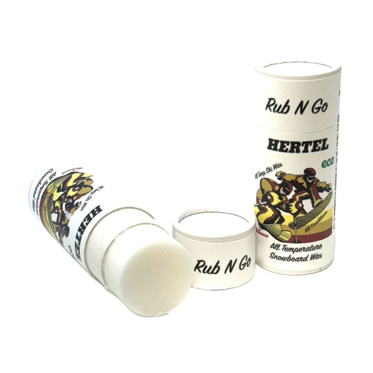 An image of an open tube of Hertel's Rub N Go ski and snowboard wax with its cap and label visible. The wax is white and the tube is cardboard with a push-up mechanism.